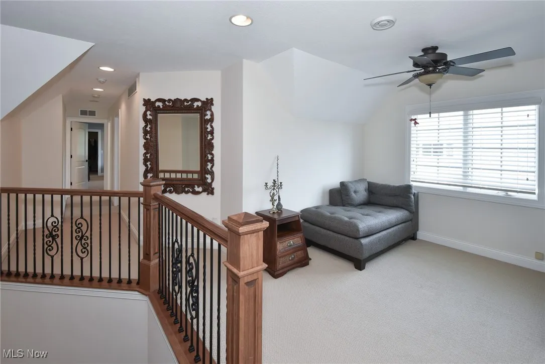 Living area with carpet floors, recessed lighting, and a ceiling fan