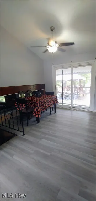 Dining room with light wood finished floors and a ceiling fan