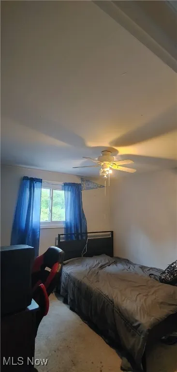 Bedroom with ceiling fan and carpet