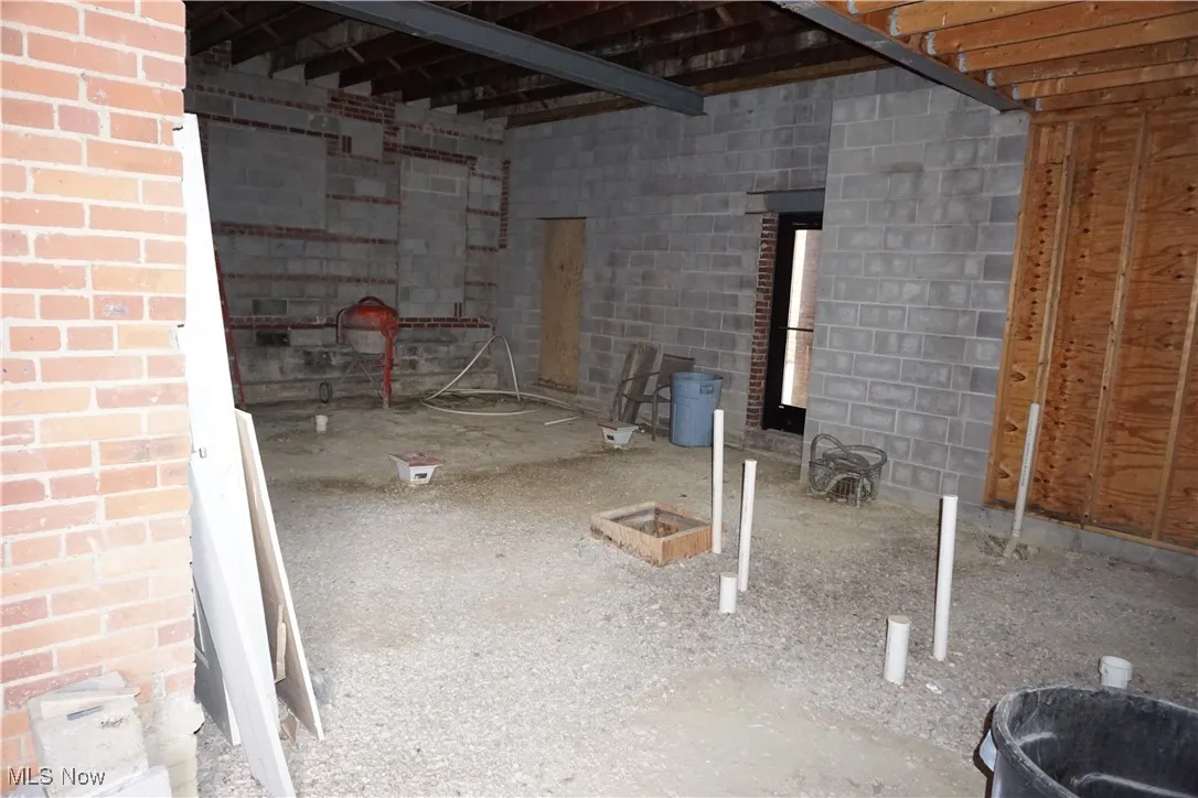 Basement featuring concrete block wall
