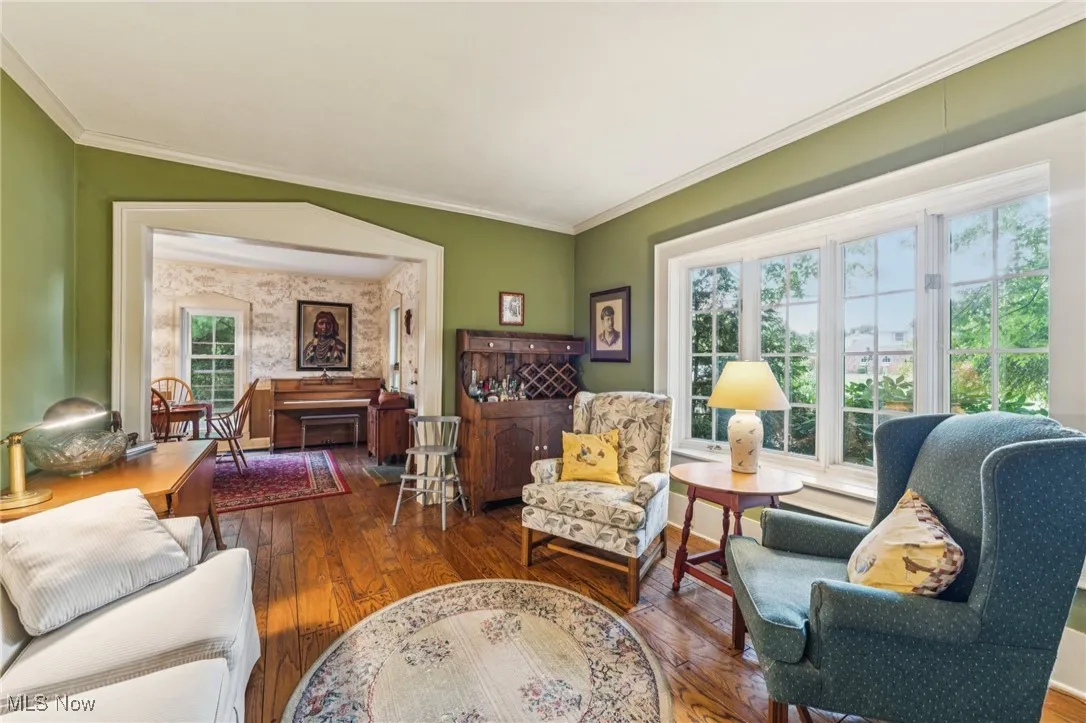 Living area featuring hardwood / wood-style floors and ornamental molding