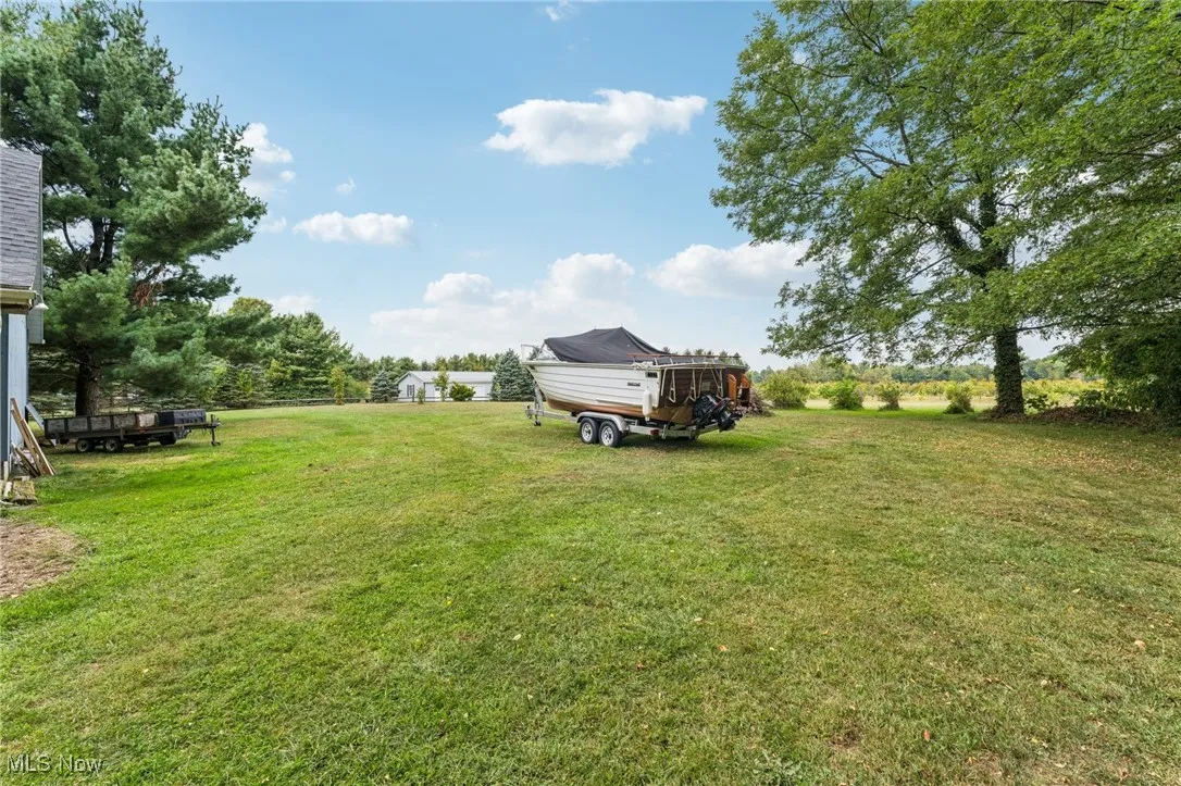 View of green lawn featuring a deck