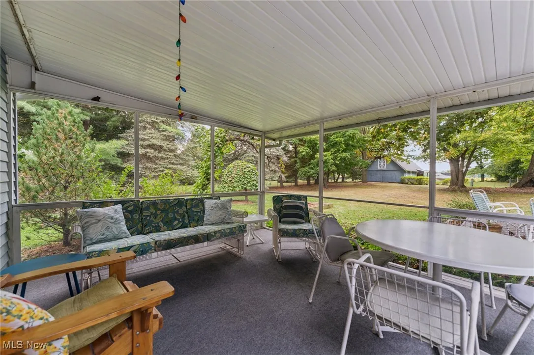Sunroom / solarium featuring outdoor lounge area and outdoor dining area