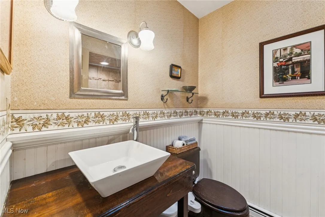 Bathroom featuring a baseboard heating unit and wainscoting
