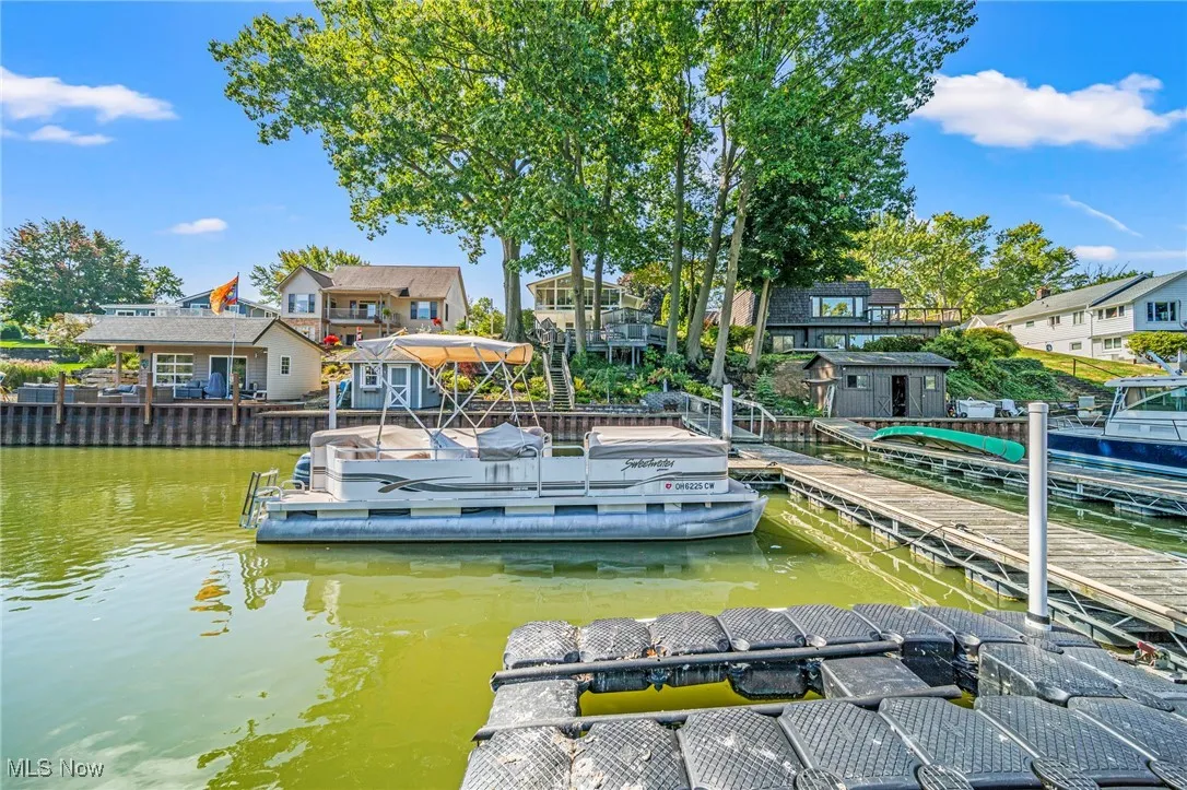 Dock featuring a residential view and a water view