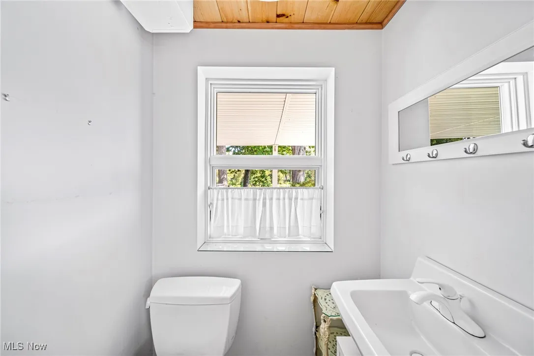 Half bath with vanity and wooden ceiling