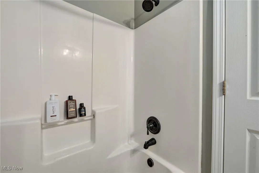 Bathroom view of washtub / shower combination