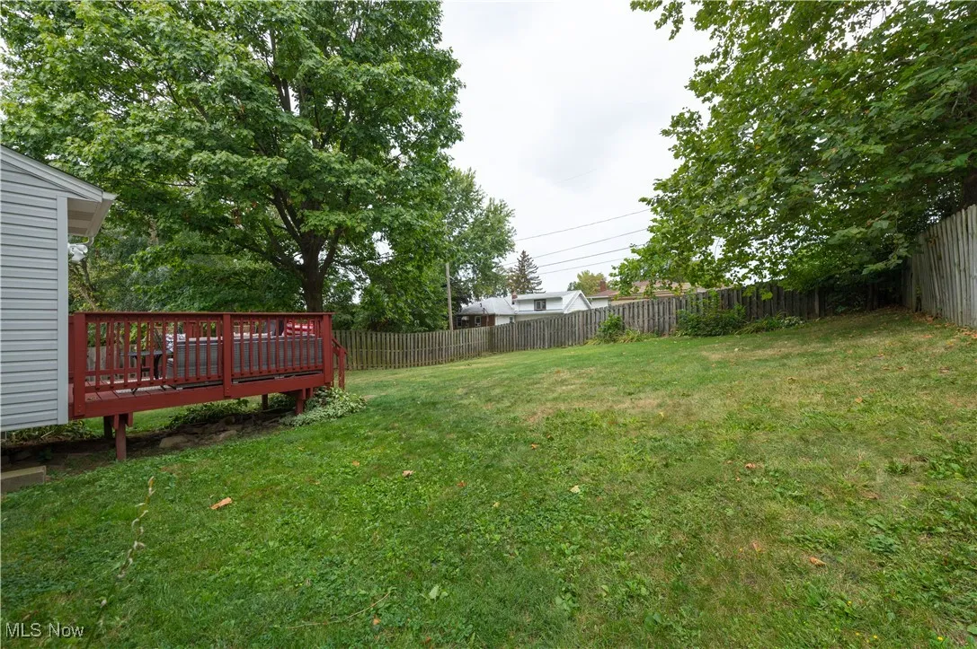 Fenced backyard featuring a deck