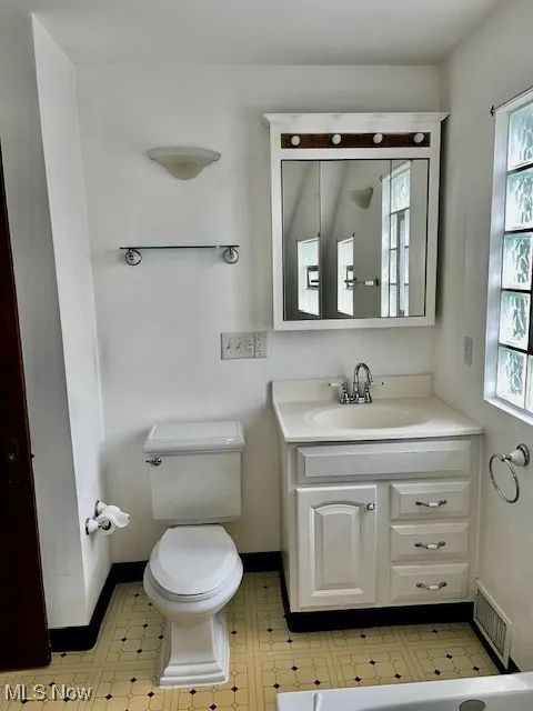 Bathroom featuring vanity and plenty of natural light