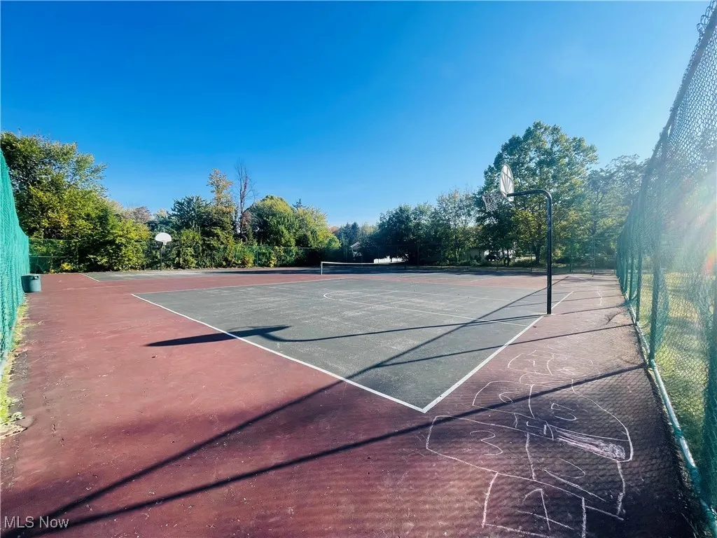 View of tennis court with community basketball court