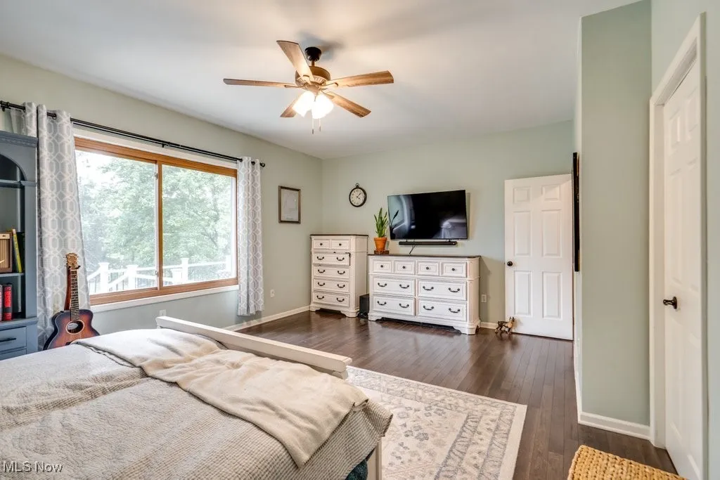 Bedroom with dark wood finished floors and ceiling fan