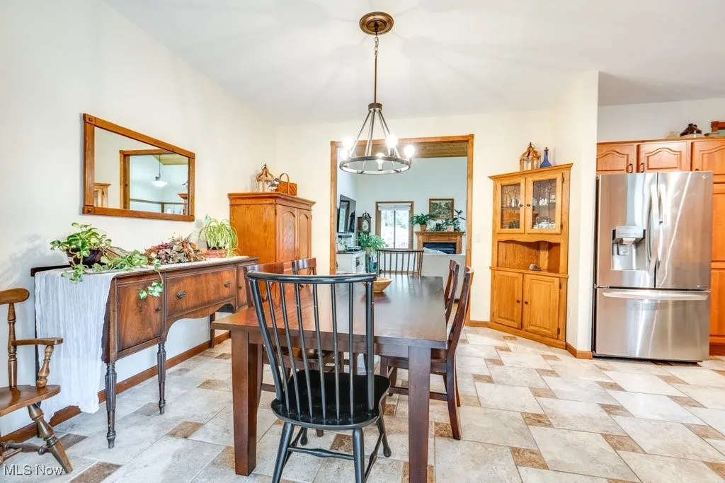 Dining room featuring baseboards and a chandelier