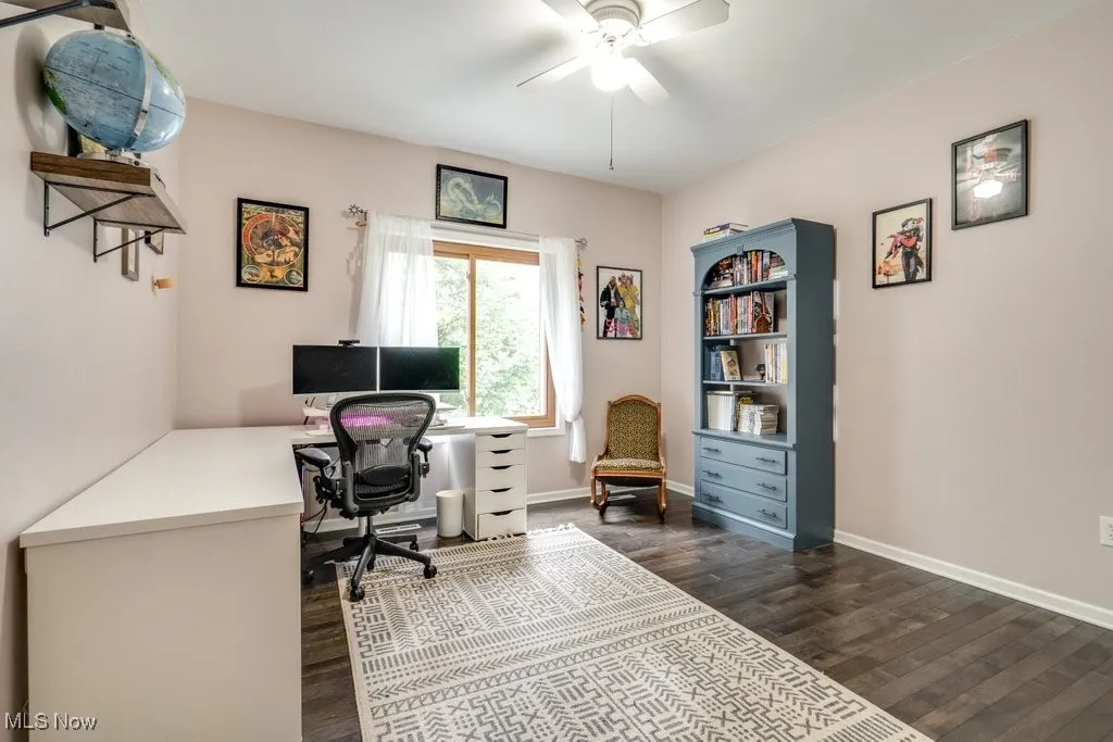 Office featuring dark wood-type flooring and a ceiling fan