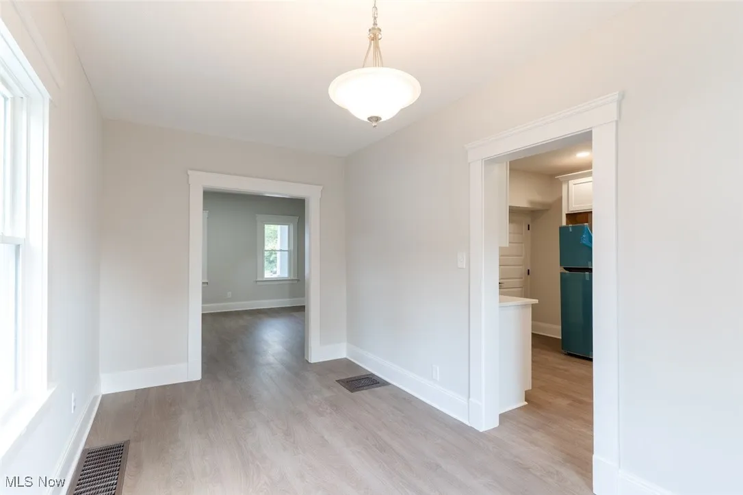 Empty room with light wood-style floors and baseboards
