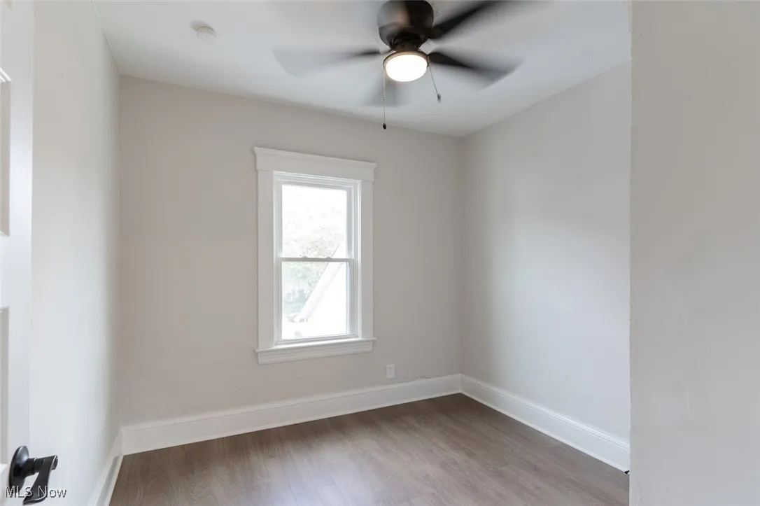 Spare room featuring light wood-type flooring and ceiling fan