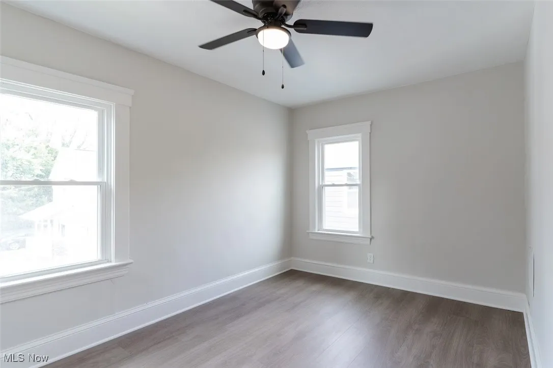 Unfurnished room featuring wood finished floors and ceiling fan