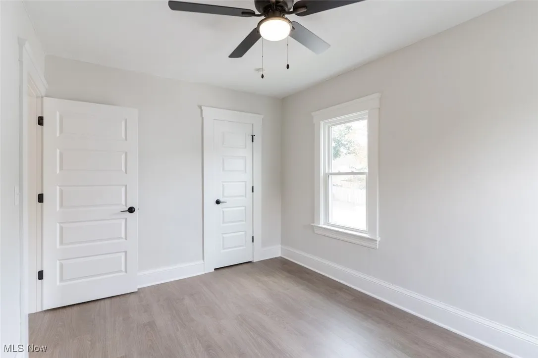 Unfurnished bedroom featuring light wood-style flooring and ceiling fan