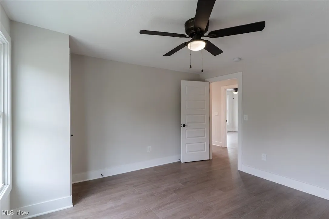 Unfurnished bedroom featuring light wood-type flooring and a ceiling fan