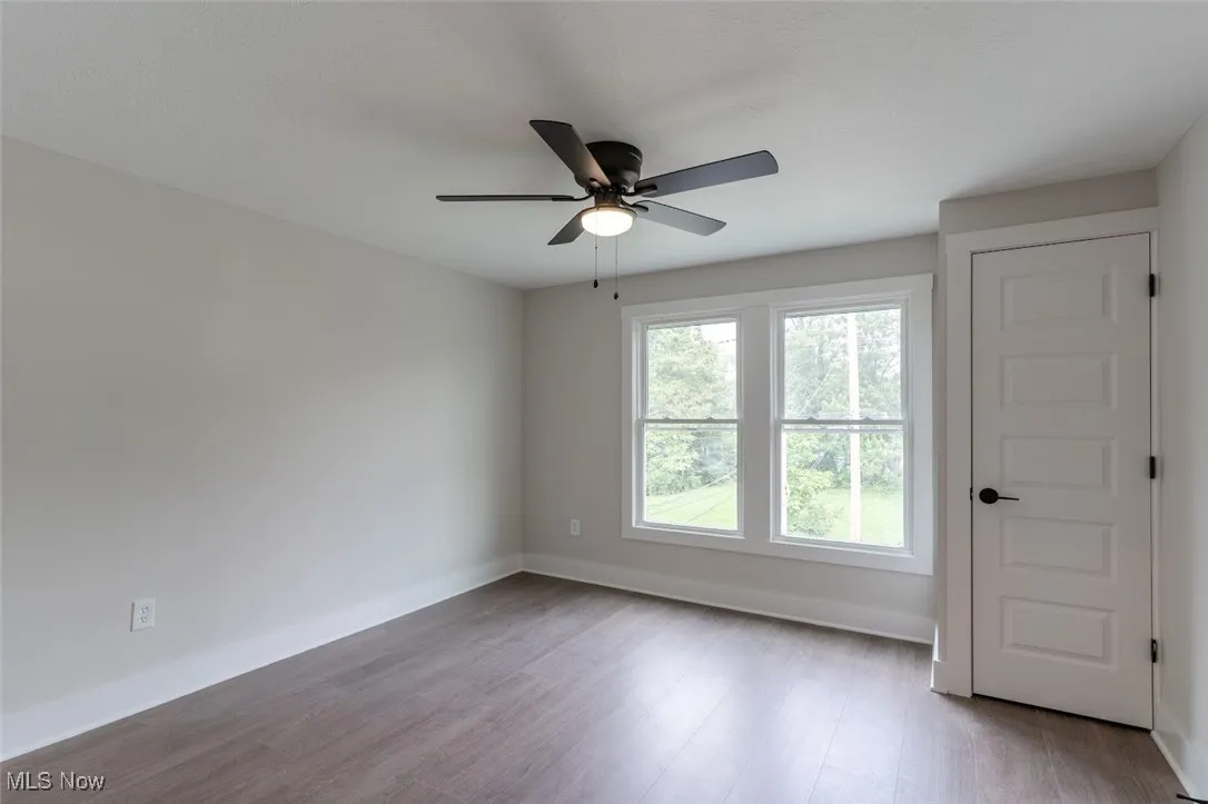 Empty room with light wood-type flooring and ceiling fan