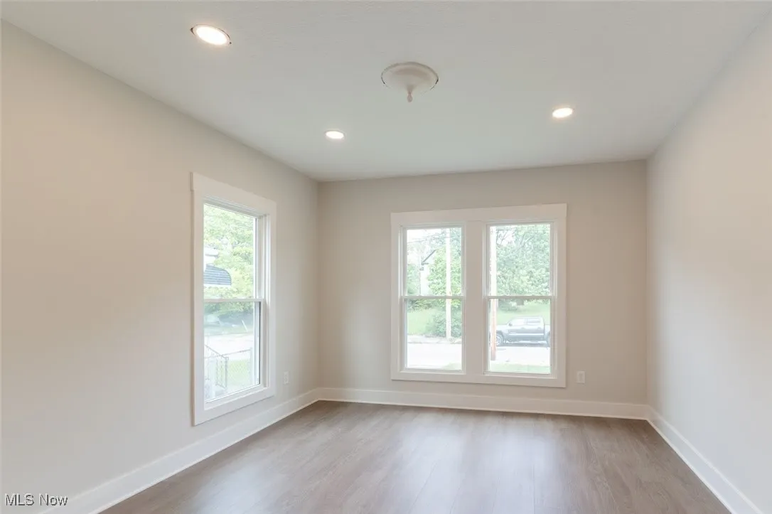 Unfurnished room featuring plenty of natural light, light wood finished floors, and recessed lighting