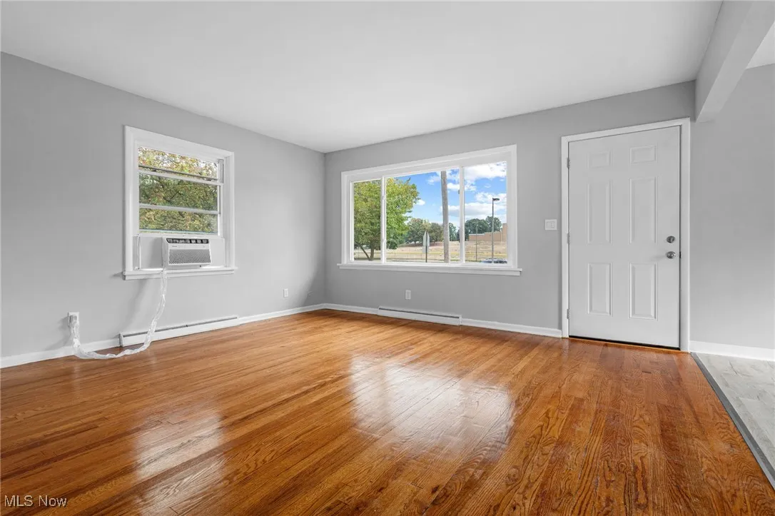 Large Living Room with wood floors & plenty of light.