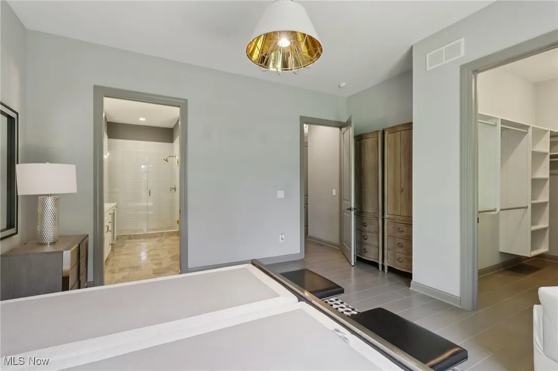 Unfurnished bedroom featuring a spacious closet and baseboards