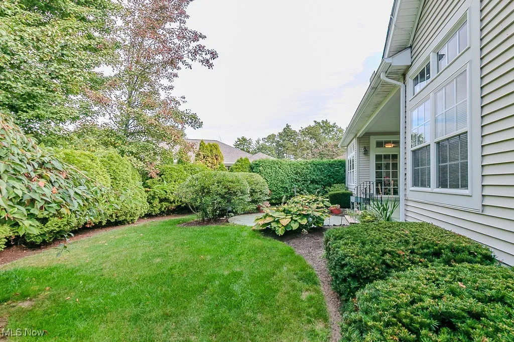 View of grassy yard featuring a patio