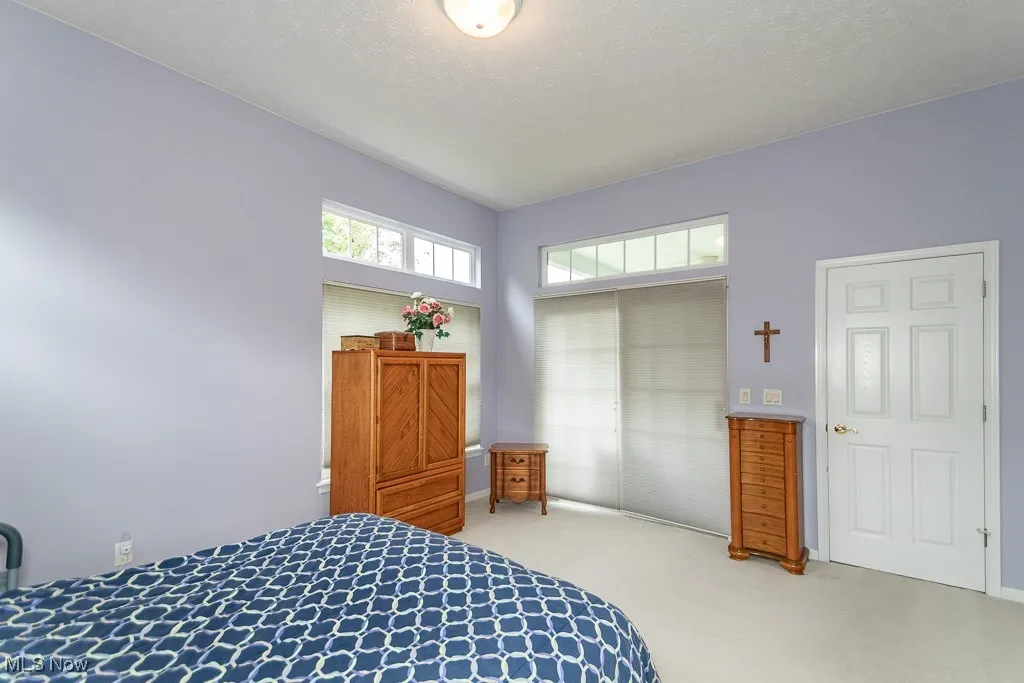 Bedroom with carpet floors, a closet, and a textured ceiling
