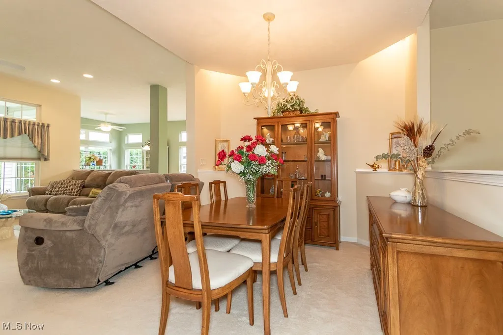 Dining space featuring recessed lighting, a chandelier, and a ceiling fan