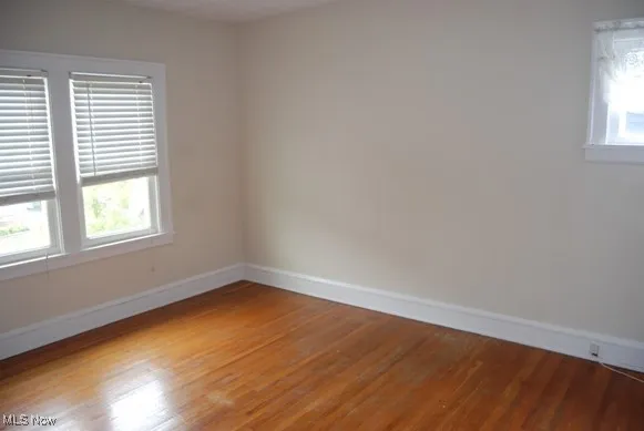 Unfurnished room featuring light wood-style flooring and baseboards