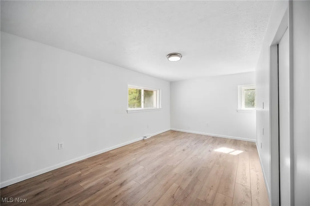 Bedroom #2 on the first floor featuring hardwood floors.