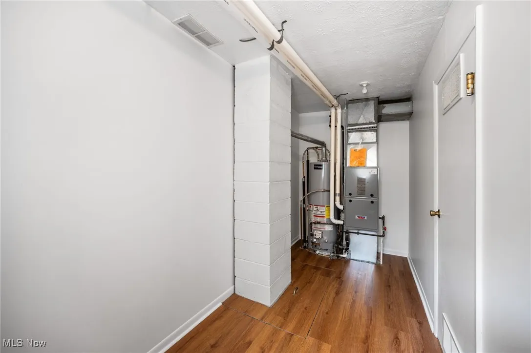 Utility room on the first floor with water heater, and a furnace #1