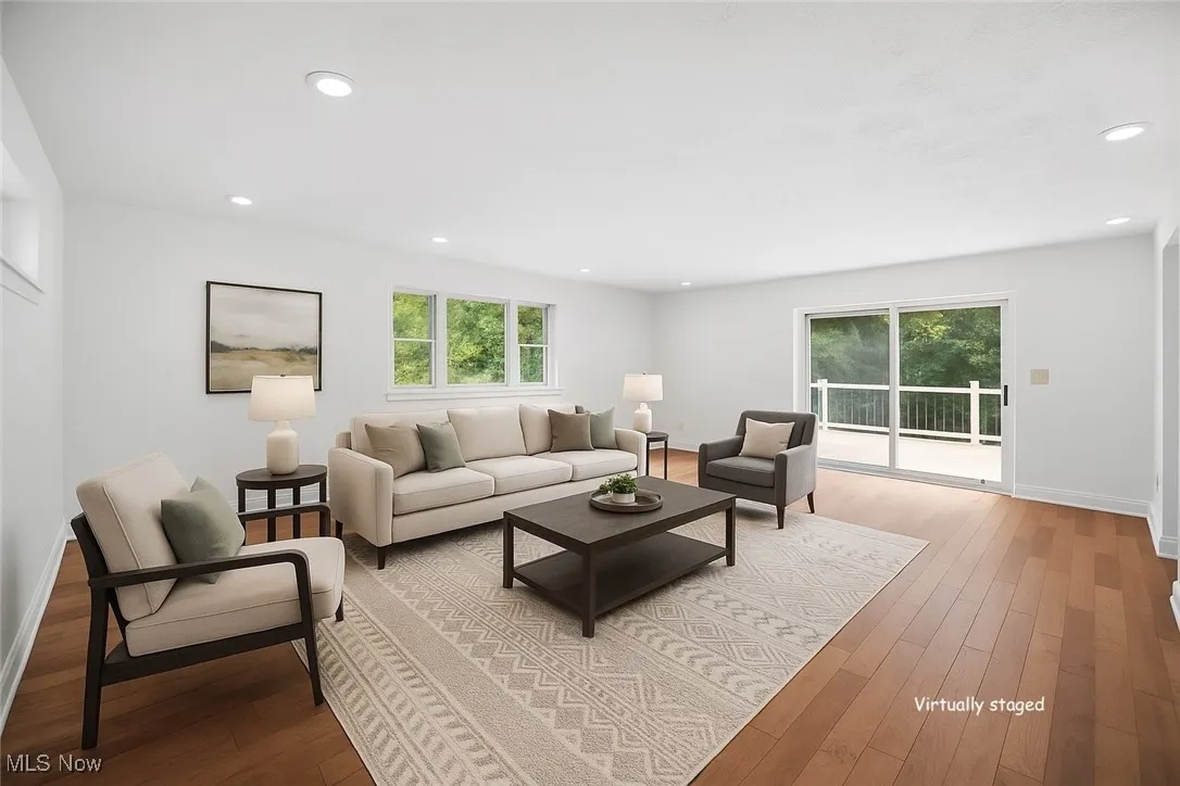 Virtually staged. Living area with hardwood floors and recessed lighting