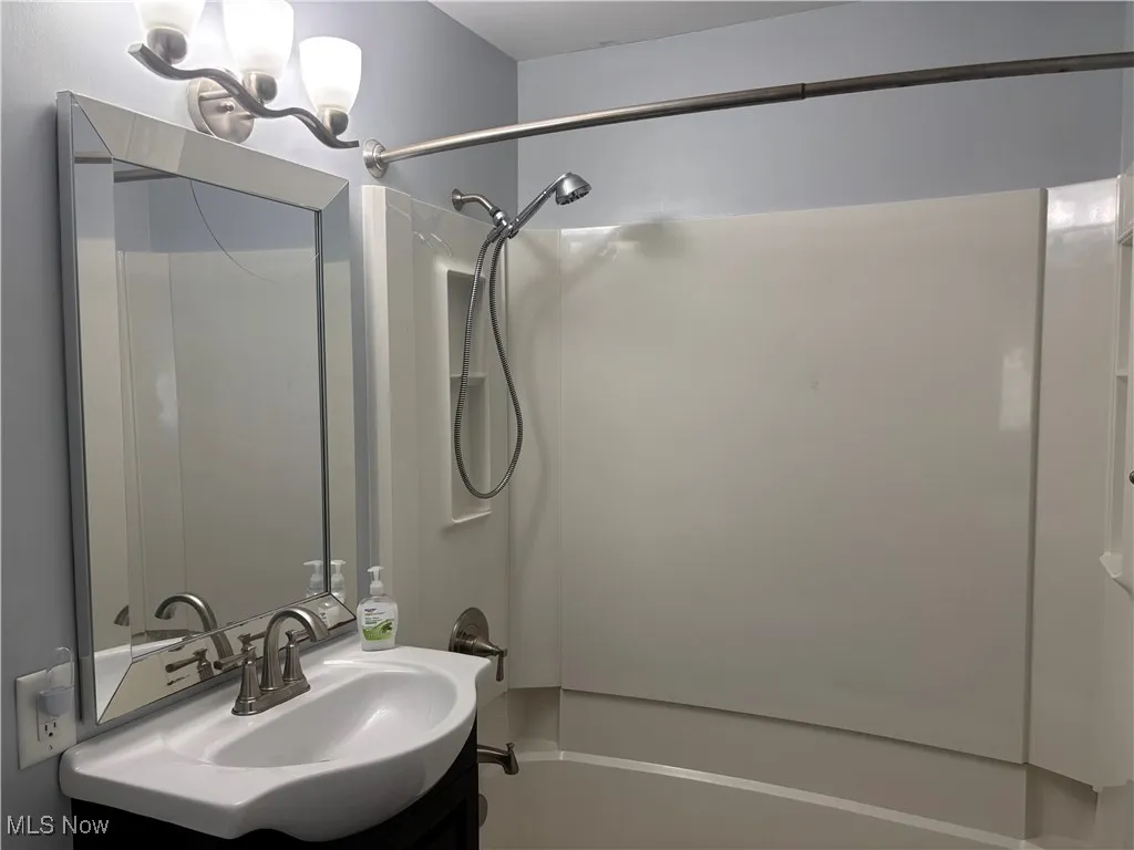 Bathroom with tub / shower combination and vanity