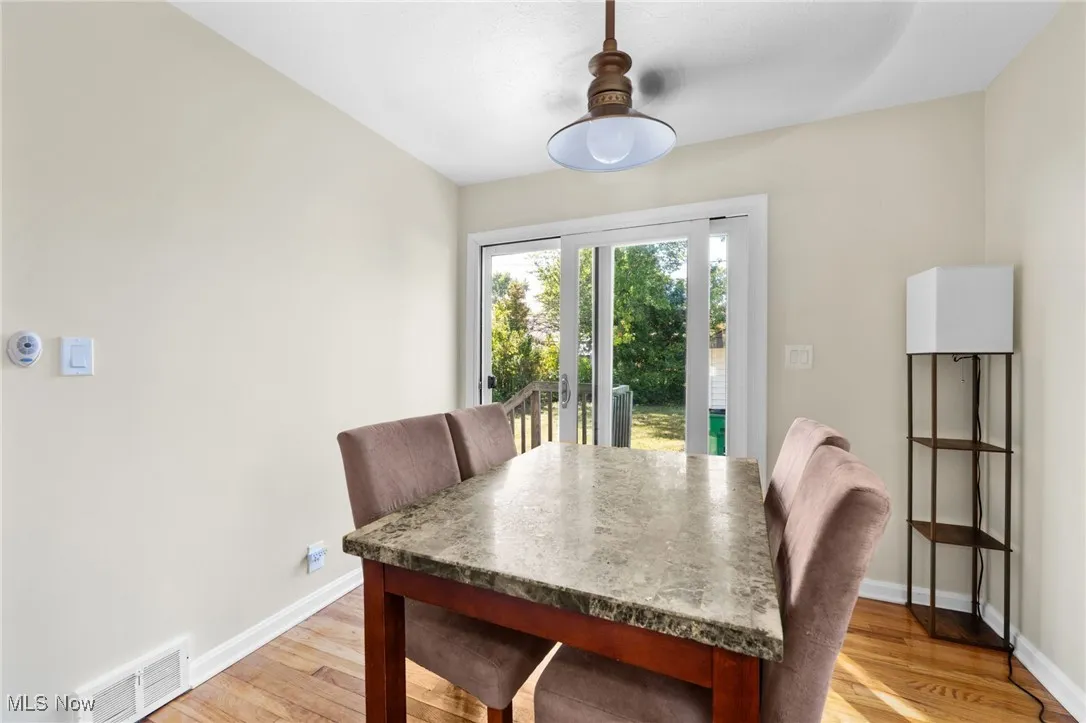 Dining area featuring light wood-style floors and baseboards