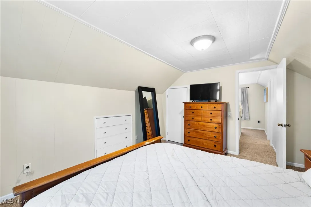 Bedroom featuring carpet floors and lofted ceiling
