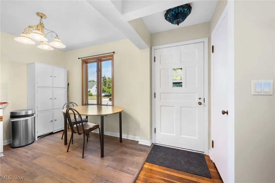Foyer entrance featuring dark wood finished floors and a chandelier