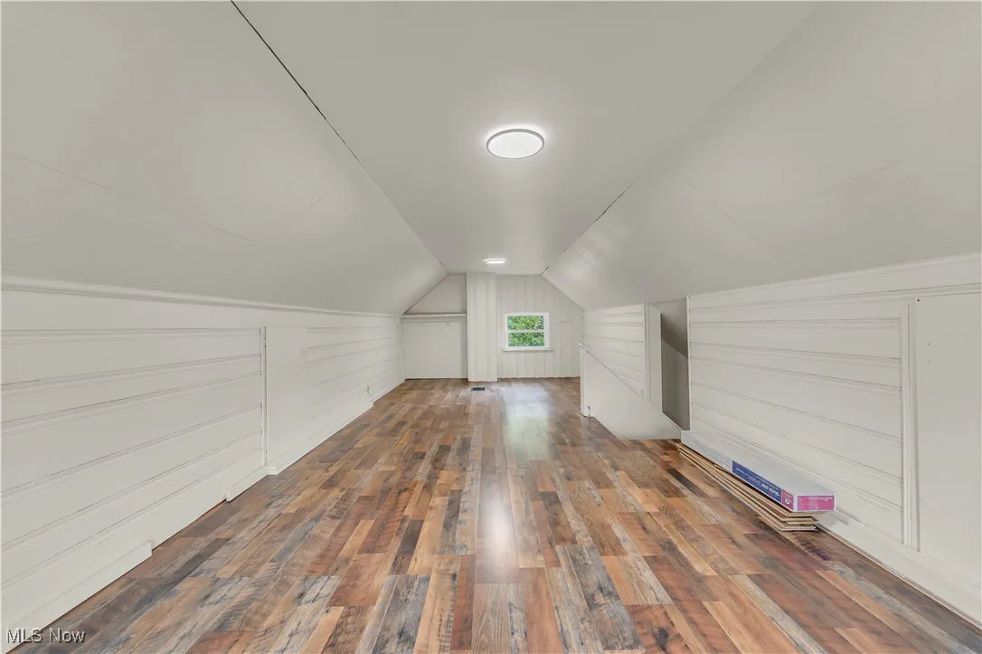 Bonus room featuring wood finished floors and vaulted ceiling