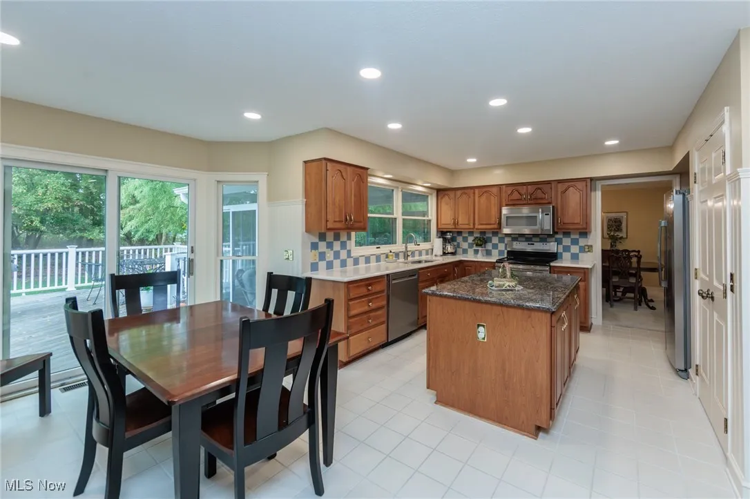 Updated kitchen with ample natural light, a large island, quartz countertops and stainless steel appliances.