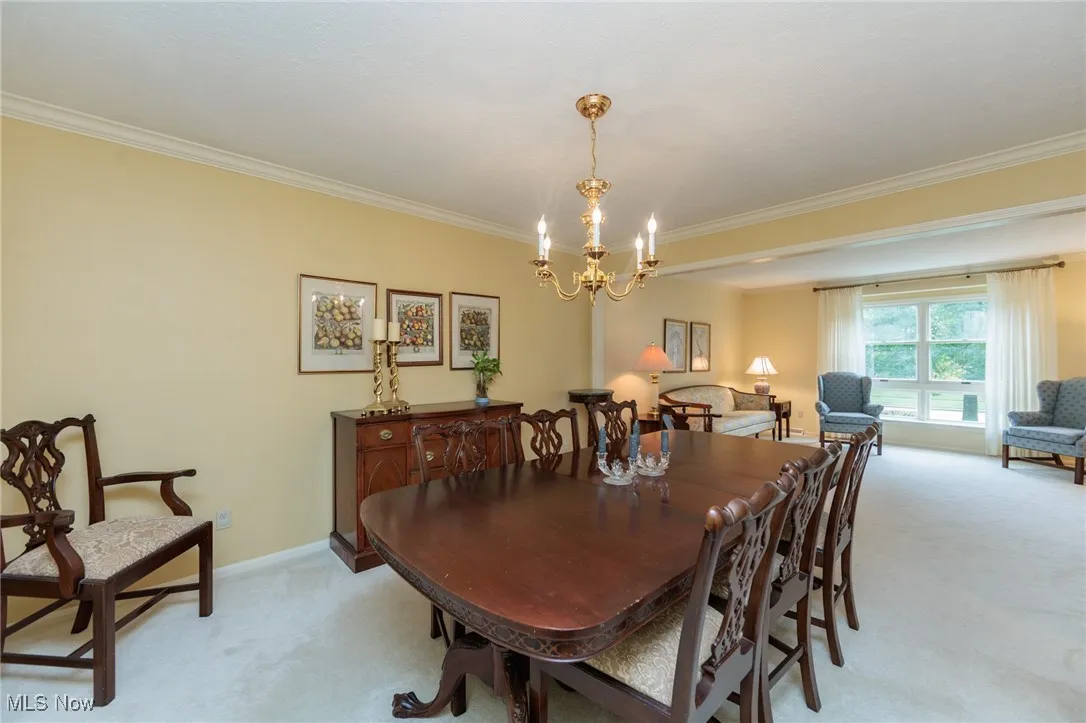 Formal Dining room with neutral carpeting.