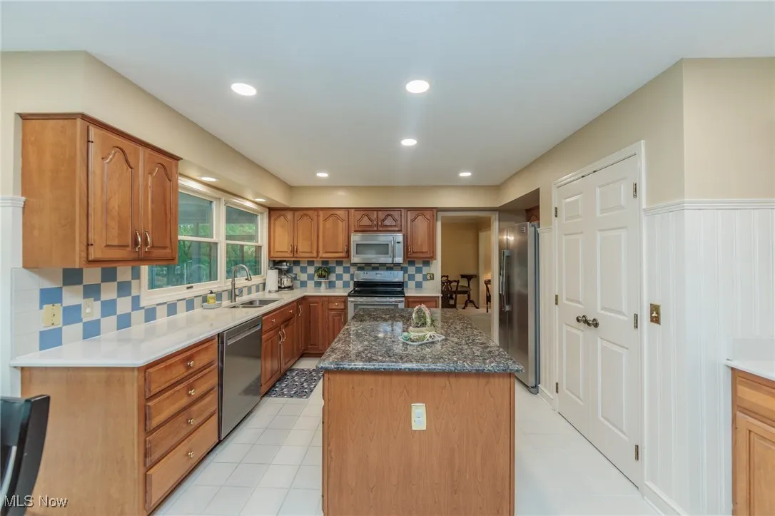 Updated kitchen with ample natural light, a large island, quartz countertops and stainless steel appliances.