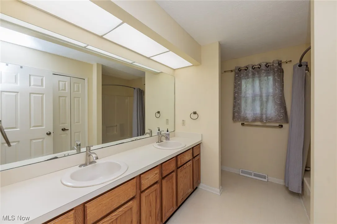Hall Bath with dual sinks and large tub/shower combination.
