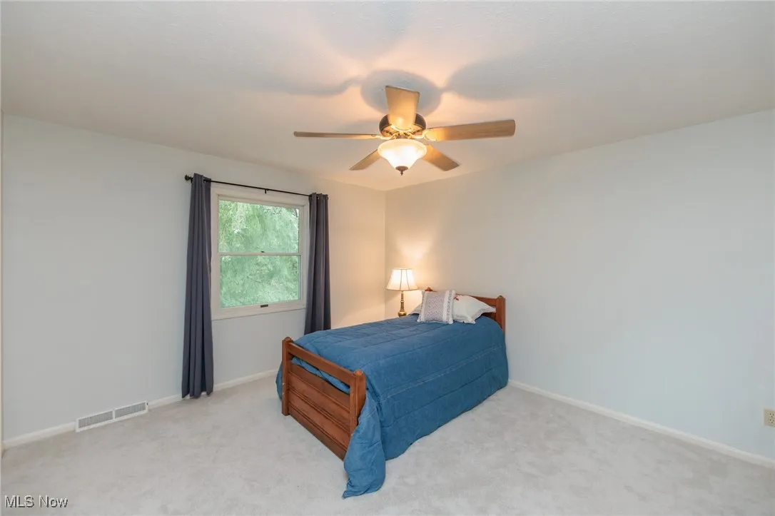 Fourth of Five Bedrooms with neutral carpeting and a ceiling fan.