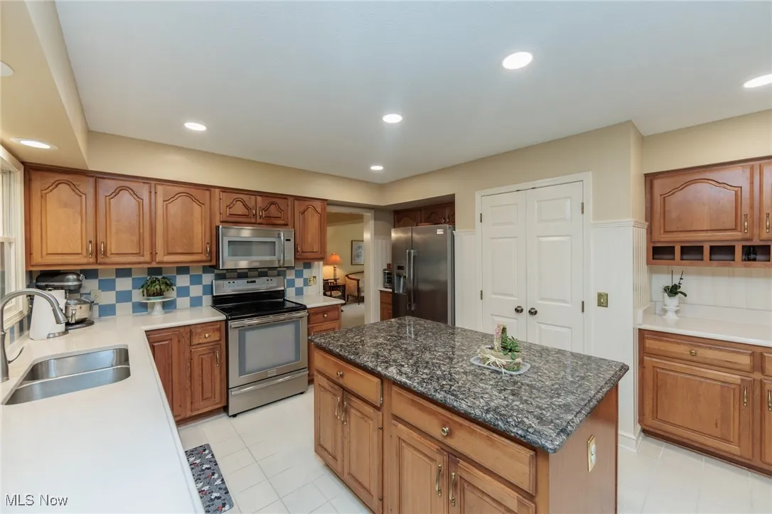 Updated kitchen with ample natural light, a large island, quartz countertops and stainless steel appliances.