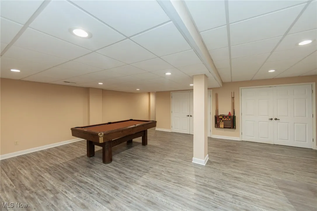 Finished lower level with several additional living spaces, newer LVT flooring, and a full bath.