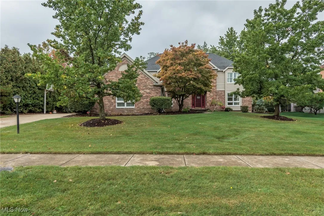 Brick and cedar front with side entry 3-car garage.