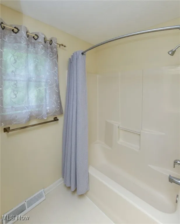Hall Bath with dual sinks and large tub/shower combination.