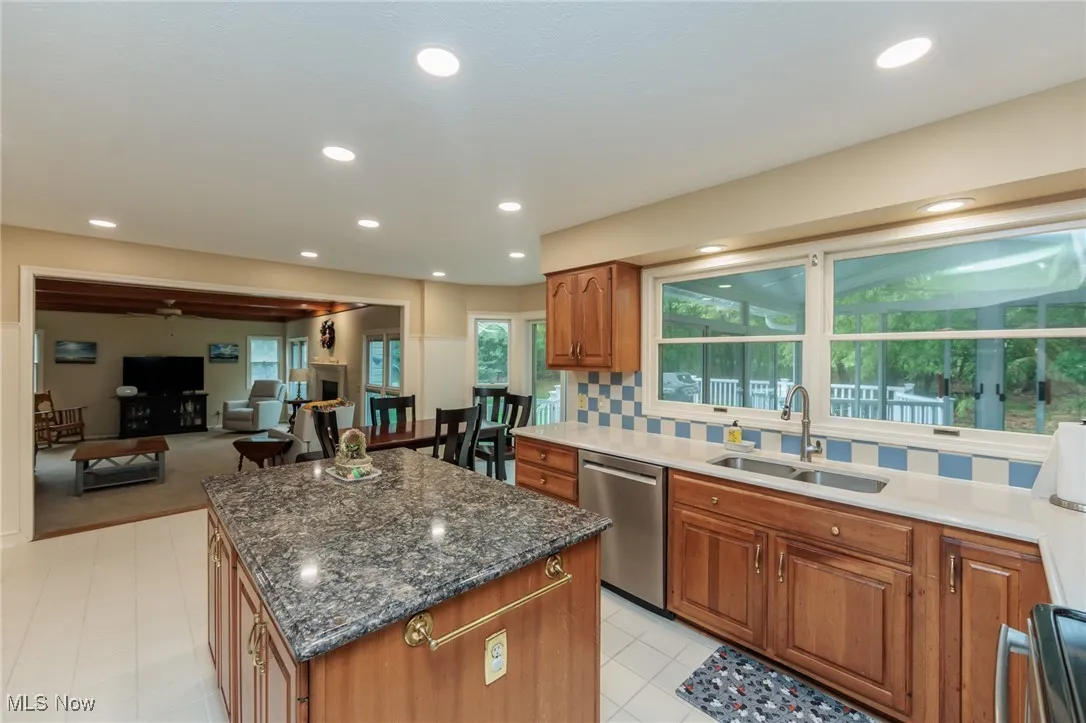 Updated kitchen with ample natural light, a large island, quartz countertops and stainless steel appliances.