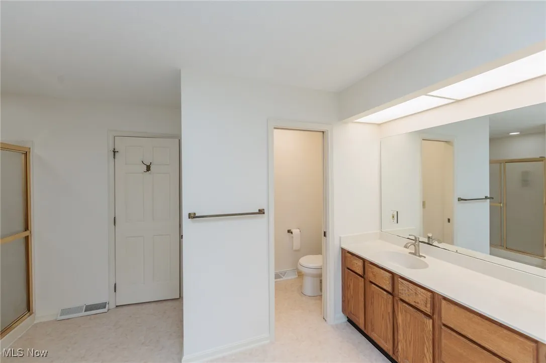 Primary Bathroom offering dual sinks, soaking garden tub, separate shower, and water closet.