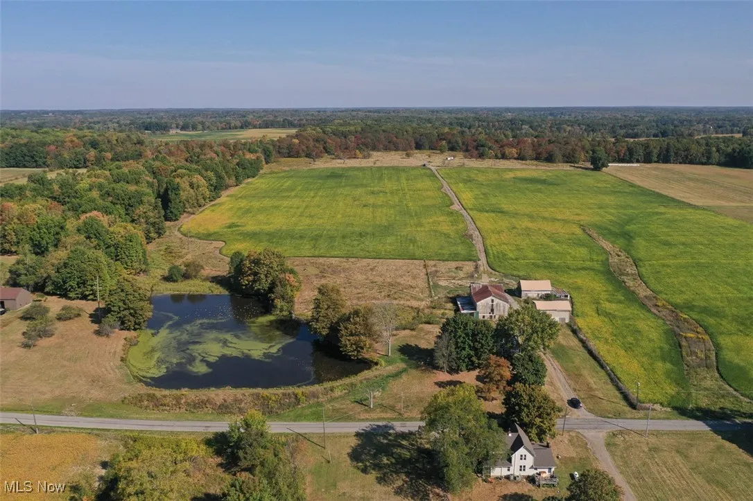 Aerial view of property and surrounding area with rural landscape and a large body of water